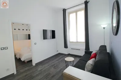a living room with a couch and a bedroom at ALC - MOL6 - 9 min Palais and 5 min Beaches in Cannes