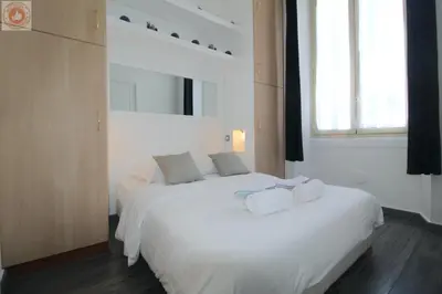 a bedroom with two beds with white sheets and a window at ALC - MOL6 - 9 min Palais and 5 min Beaches in Cannes
