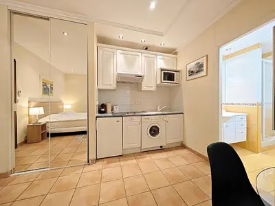a kitchen with a sink and a washing machine at Viva Riviera Residence Commandant André in Cannes