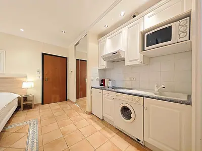 a kitchen with a washer and dryer in a room at Viva Riviera Residence Commandant André in Cannes