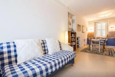a blue and white couch in a living room at Large 1 Bedroom with Balcony City Centre in Cannes