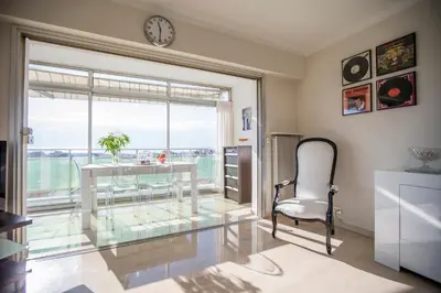 a glass table and a chair in a room with a window at Central Park by Connexion in Cannes