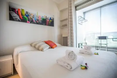 a bedroom with two white towels on a bed at Central Park by Connexion in Cannes