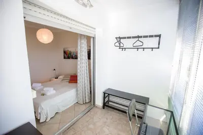 a small bedroom with a bed and a window at Central Park by Connexion in Cannes