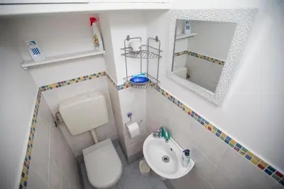 a small bathroom with a toilet and a sink at Central Park by Connexion in Cannes