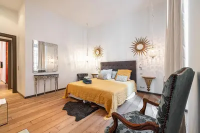 a bedroom with a bed and a table and chairs at The Cosmopolitan Lodge in Cannes