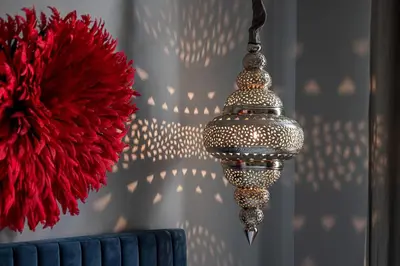 a chandelier hanging from a wall with a red ball at The Cosmopolitan Lodge in Cannes