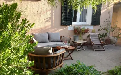 a patio with a couch and chairs and a table at Villa Prétorina in Cannes