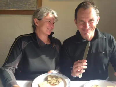 a man and woman sitting at a table with a plate of food at Villa Prétorina in Cannes