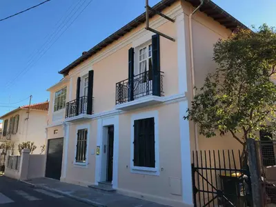 a white house with black balconies on a street at Villa Prétorina in Cannes