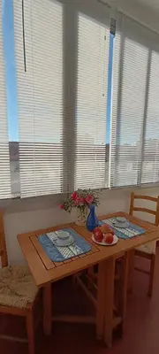 a wooden table with fruit on it in a room with windows at Studio Montfleury in Cannes