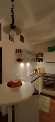 a kitchen with a bowl of fruit on a table at Studio Montfleury in Cannes