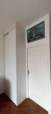a white cabinet next to a door with a picture on it at Studio Montfleury in Cannes