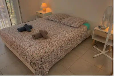 a bedroom with a bed with two teddy bears on it at Beau 2 pièces 3 étoiles Vue Mer Garage Privé 150m plages wifi in Cannes