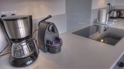 a blender sitting on top of a kitchen counter at Beau 2 pièces 3 étoiles Vue Mer Garage Privé 150m plages wifi in Cannes