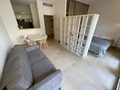 a living room with a couch and a table at Appartements Villa Rimbaud by Connexion in Cannes
