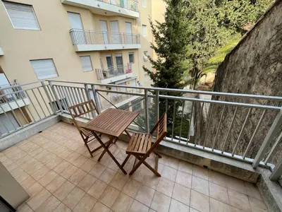 a patio with two chairs and a table on a balcony at Appartements Villa Rimbaud by Connexion in Cannes