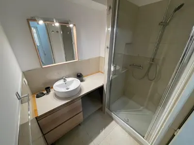 a bathroom with a sink and a shower at Appartements Villa Rimbaud by Connexion in Cannes