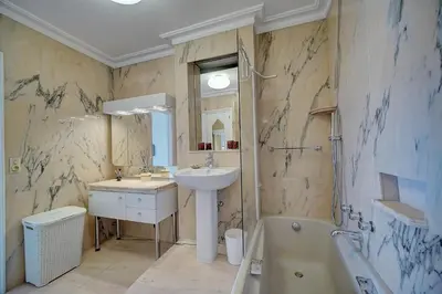 a bathroom with a sink and a toilet and a tub at IMMOGROOM- Huge Terrace - Panoramic Sea View - 1min from Beach in Cannes