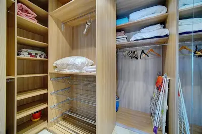 a walk in closet with wooden walls and wooden shelves at IMMOGROOM- Huge Terrace - Panoramic Sea View - 1min from Beach in Cannes