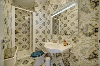 a bathroom with a sink and a toilet at IMMOGROOM- Huge Terrace - Panoramic Sea View - 1min from Beach in Cannes