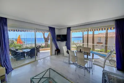 a living room with a view of the ocean at IMMOGROOM- Huge Terrace - Panoramic Sea View - 1min from Beach in Cannes