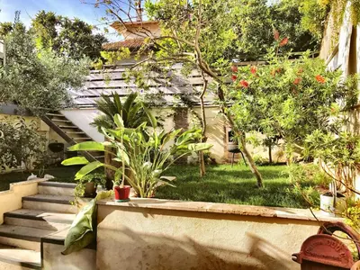 a garden with stairs and plants in front of a building at B&B Villa Du Roc Fleuri in Cannes