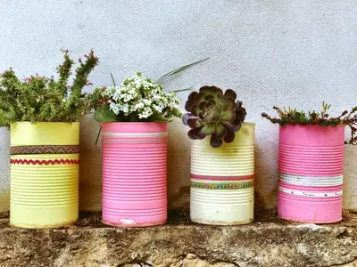 four pink and yellow vases with flowers in them at B&B Villa Du Roc Fleuri in Cannes