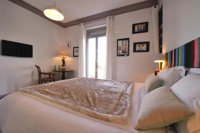 a bedroom with a bed with a blanket on it at B&B Villa Du Roc Fleuri in Cannes