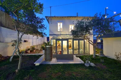 a house with a glass door in a yard at B&B Villa Du Roc Fleuri in Cannes