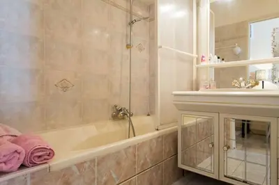 a dining room with a table and white chairs at lovely apartments with terrace in Cannes