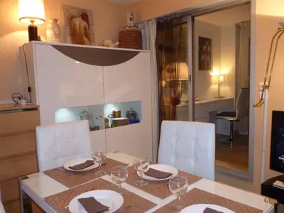 a kitchen counter with a coffee maker and a bottle of wine at lovely apartments with terrace in Cannes