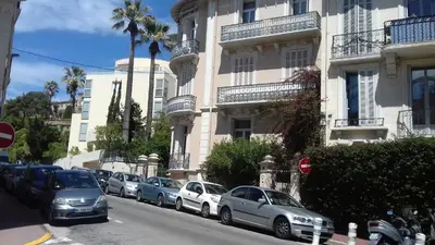 a patio with a wooden deck with a bench and plants at lovely apartments with terrace in Cannes