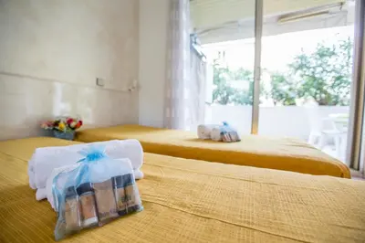 two beds in a hotel room with towels on them at Appartement et Parking Cannes Center by Connexion in Cannes