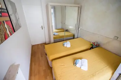 two beds in a small room with a mirror at Appartement et Parking Cannes Center by Connexion in Cannes