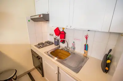 a small kitchen with a sink and a stove at Appartement et Parking Cannes Center by Connexion in Cannes