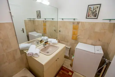 a bathroom with a sink and a toilet and a mirror at Appartement et Parking Cannes Center by Connexion in Cannes