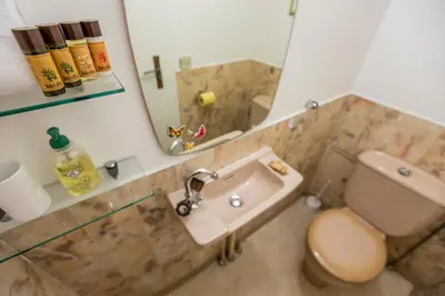 a bathroom with a sink and a toilet and a mirror at Appartement et Parking Cannes Center by Connexion in Cannes