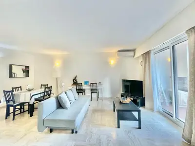 a living room with a couch and a table at Arènes by Welcome to Cannes in Cannes