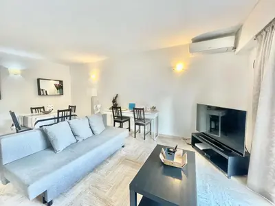 a living room with a couch and a table at Arènes by Welcome to Cannes in Cannes