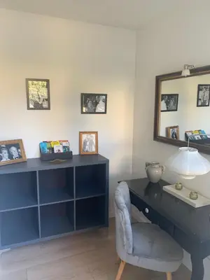 a blue desk with a chair and a mirror at APPART' CANNES in Cannes