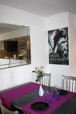 a dining room table with a purple table cloth at APPART' CANNES in Cannes