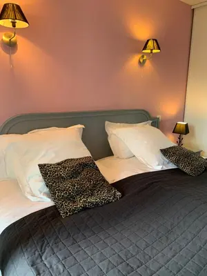 a bedroom with a bed with two pillows on it at APPART' CANNES in Cannes