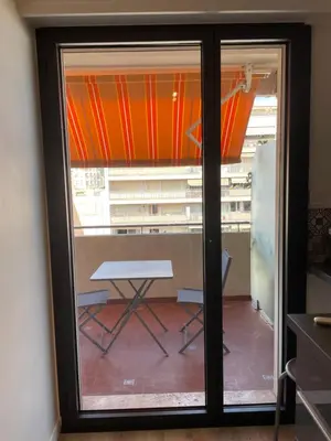 a sliding glass door with a table in a room at Le Suquetan in Cannes