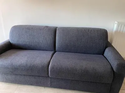 a blue couch sitting in a living room at Le Suquetan in Cannes
