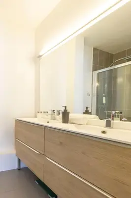 a bathroom with two sinks and a large mirror at Modern apartment 2 bedrooms1 bathroom quiet terrace in a palm beach area in Cannes