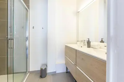 a bathroom with a sink and a glass shower at Modern apartment 2 bedrooms1 bathroom quiet terrace in a palm beach area in Cannes