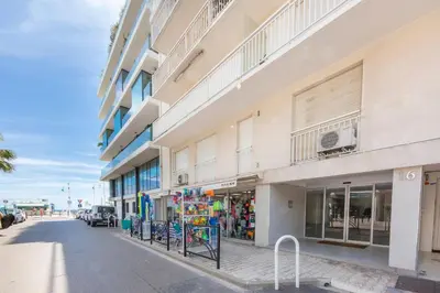 a building on the side of a street at Modern apartment 2 bedrooms1 bathroom quiet terrace in a palm beach area in Cannes