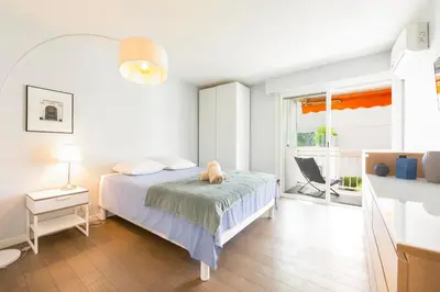 a bedroom with a bed with a teddy bear on it at Modern apartment 2 bedrooms1 bathroom quiet terrace in a palm beach area in Cannes