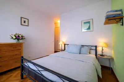 a bedroom with a bed and a dresser and two lamps at Villa Cannes I Deluxe Seafront - Sea View - Garden & Terrace -Prime Location- in Cannes